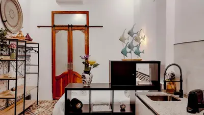 a kitchen with a counter with a sink and a stove at Casa del Cabanal La Playa Azul cobalto in Valencia
