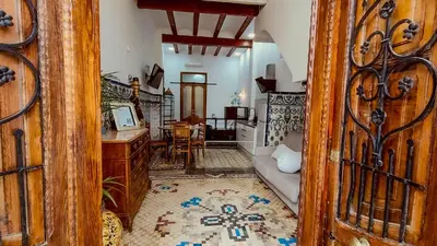 a room with a wooden door and a living room at Casa del Cabanal La Playa Azul cobalto in Valencia