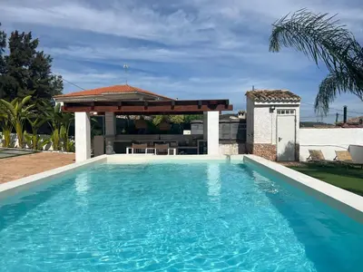 a swimming pool with a gazebo in a backyard at Villa con piscina en la montaña in Llombay