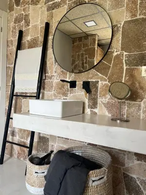 a bathroom with a sink and a mirror at Villa con piscina en la montaña in Llombay