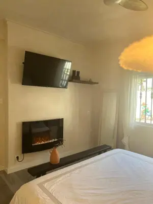 a bedroom with a bed and a fire place at Villa con piscina en la montaña in Llombay