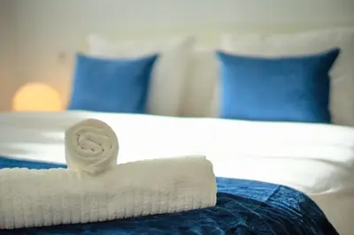 a rolled up towel sitting on top of a bed at Apto 2 P Ferrandis in Valencia