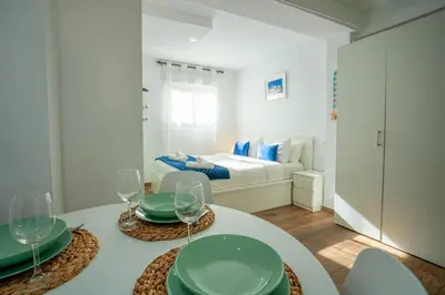 a white room with a table and chairs and a bed at Apto 2 P Ferrandis in Valencia