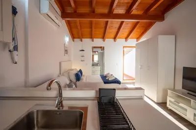 a kitchen with a sink and a bed in the background at Apto 3 P Ferrandis in Valencia