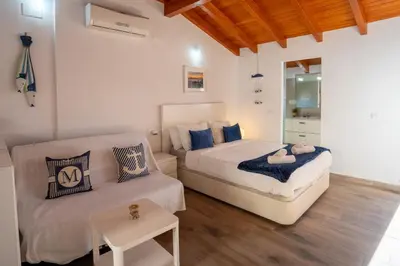 a bedroom with two beds and a couch in it at Apto 3 P Ferrandis in Valencia