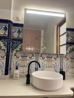 a bathroom with a sink and a large mirror at casa del Cabanyal La Playa in Valencia