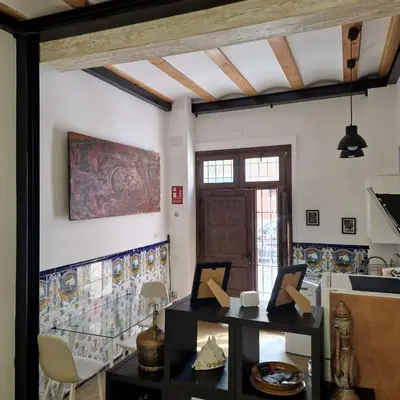 a room with a table and a painting on the wall at casa del Cabanyal La Playa in Valencia
