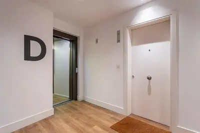 a hallway with a white door and a mirror at Valencia City Apartment with Gym Pool Free Parking TheHavenEscape in Valencia
