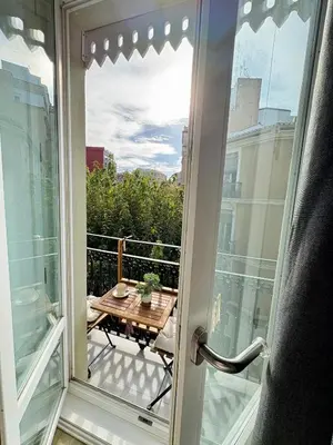 a sliding glass door to a balcony with a table at Valencia City Apartment with Gym Pool Free Parking TheHavenEscape in Valencia