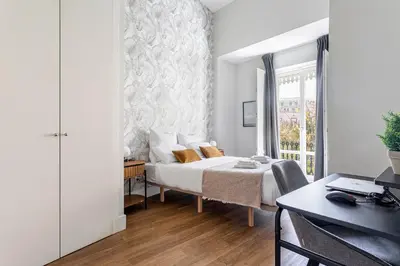 a bedroom with a bed and a desk at Valencia City Apartment with Gym Pool Free Parking TheHavenEscape in Valencia