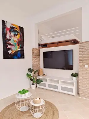 a living room with a flat screen tv at Loft DobleAltura Escalante in Valencia
