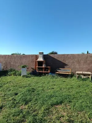 a building with a roof on top of a grass field at Valencia Autentica, Casa Rural 