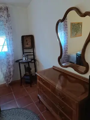 a room with a dresser and a mirror on the wall at Valencia Autentica, Casa Rural 