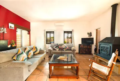 a living room with a couch and a stove at Valencia Autentica, Casa Rural 