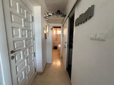 a hallway with a white door and a hallway with a corridorngthngthngthngth at El Prado - Primera Línea Playa Cullera in Valencia