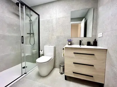 a bathroom with a toilet and a sink and a shower at Convenient, Charming Apartment 15 Mins from City Center in Valencia