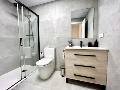 a bathroom with a toilet and a sink and a shower at Convenient, Charming Apartment 15 Mins from City Center in Valencia