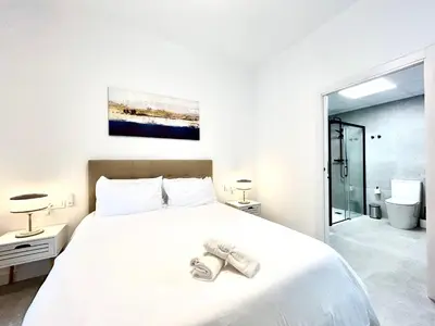 a bedroom with a large white bed with shoes on it at Strategic Stay-Unlock Valencia's Best-Kept Secret in Valencia