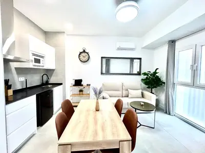 a living room with a table and a couch at Strategic Stay-Unlock Valencia's Best-Kept Secret in Valencia