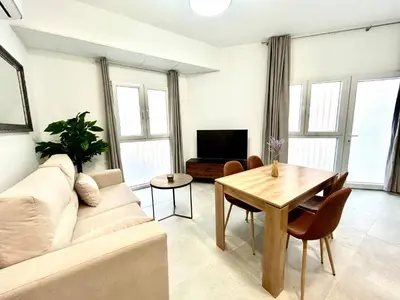 a living room with a couch and a table at Strategic Stay-Unlock Valencia's Best-Kept Secret in Valencia