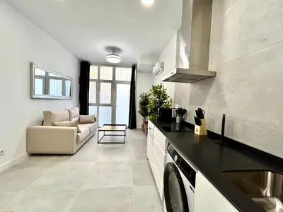 a kitchen and living room with a washer and dryer at Valencia Urban Escape Comfort Meets Luxury, 4 Ppl in Valencia