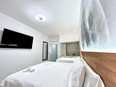 a bedroom with a large bed with a flat screen tv at Valencia Urban Escape Comfort Meets Luxury, 4 Ppl in Valencia