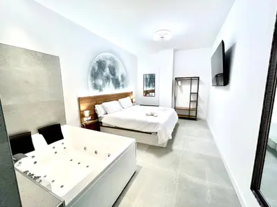 a bedroom with a bed and a bathtub and a bath tub at Valencia Urban Escape Comfort Meets Luxury, 4 Ppl in Valencia