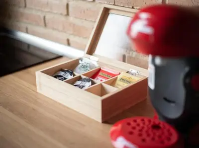 a wooden box with shoes in it on a table at New Light Cozy Stay Ruzafa in Valencia