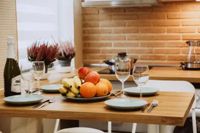 a table with a plate of fruit and wine glasses at New Light Cozy Stay Ruzafa in Valencia