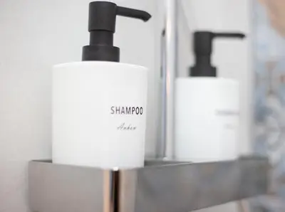 a group of three soap dispensers sitting next to each other at New Light Cozy Stay Ruzafa in Valencia