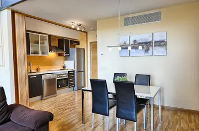 a kitchen and dining room with a table and chairs at Ohmyloft Valencia in Burjasot