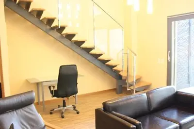a room with a desk and a chair and a staircase at Ohmyloft Valencia in Burjasot