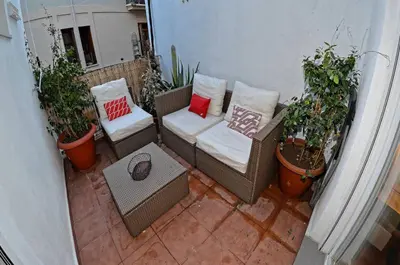a patio with a couch and some potted plants at Apartamento Gutenberg in Valencia