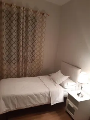 a bedroom with a white bed and a window at Apartamento Gutenberg in Valencia