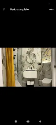 a bathroom with a sink and a toilet and a mirror at Apartamento ideal en calle florista in Valencia