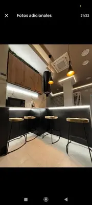 a kitchen with two stools and a counter top at Apartamento ideal en calle florista in Valencia