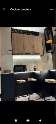 a kitchen with two stools and a counter top at Apartamento ideal en calle florista in Valencia