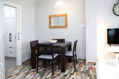 a dining room with a black table and chairs at District Key - Carricola in Valencia
