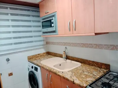 a kitchen with a sink and a washing machine at Los Olivos BB1 in Faro de Cullera