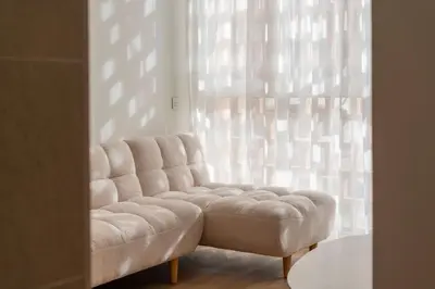 a white couch sitting in front of a window at VLC HOST - Molinell in Valencia