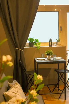 a bedroom with a large bed and a table at CITY FLATS - Avenida Baleares in Valencia