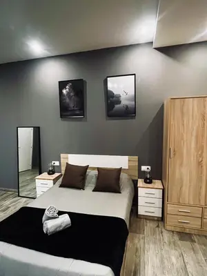 a bedroom with a large bed and two night stands at CITY FLATS - Avenida Baleares in Valencia