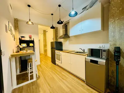 a kitchen with white cabinets and a counter top at ORI B Nice & Spacious Flat Close to the Center in Valencia
