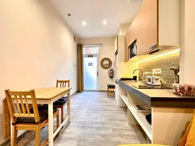a kitchen with a wooden table and a dining room at Lofts Casa Tropicana in Valencia