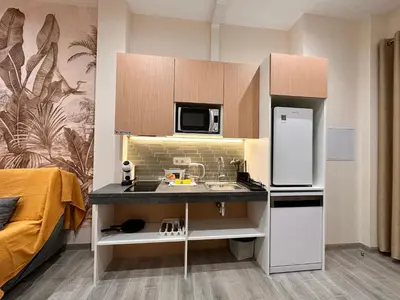 a small kitchen with a sink and a refrigerator at Lofts Casa Tropicana in Valencia