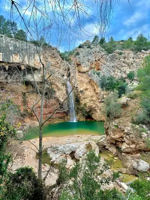 a waterfall in a canyon with a pool of water at Paraiso Natural Unico -Villa Cueva Turche in Valencia