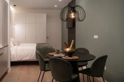 a room with a table and chairs and a bed at Green Luxury Zamenhof in Valencia