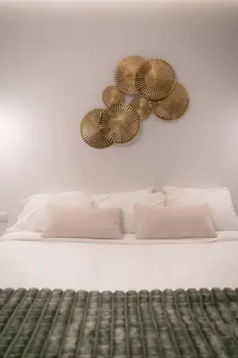 a bedroom with a bed with two mirrors on the wall at Green Luxury Zamenhof in Valencia