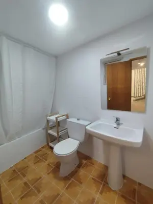 a bathroom with a white toilet and a sink at Casa Centenaria en Cortes de Pallás in Cortez de Pallas