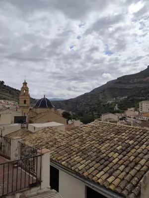 a view of a roof of a town with mountains at Casa Centenaria en Cortes de Pallás in Cortez de Pallas